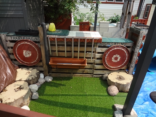 Outdoor area with chimes and drums.