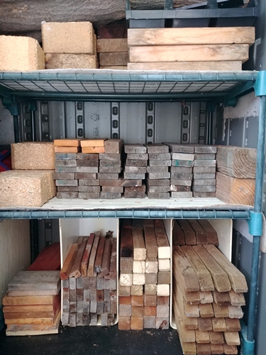 Various types of stacked wood pieces.